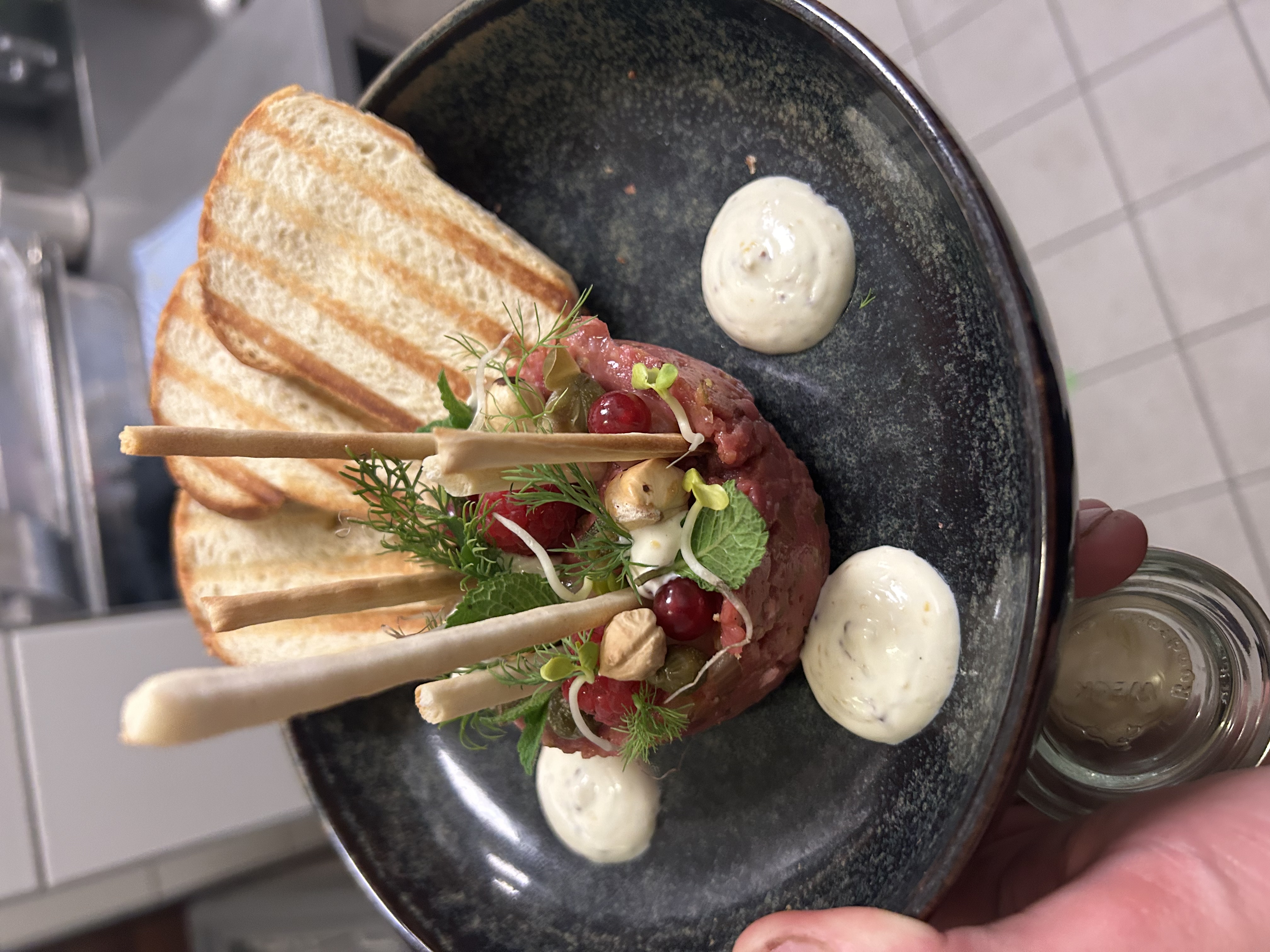 Hand-cut tartare with toasted bread and fresh herbs