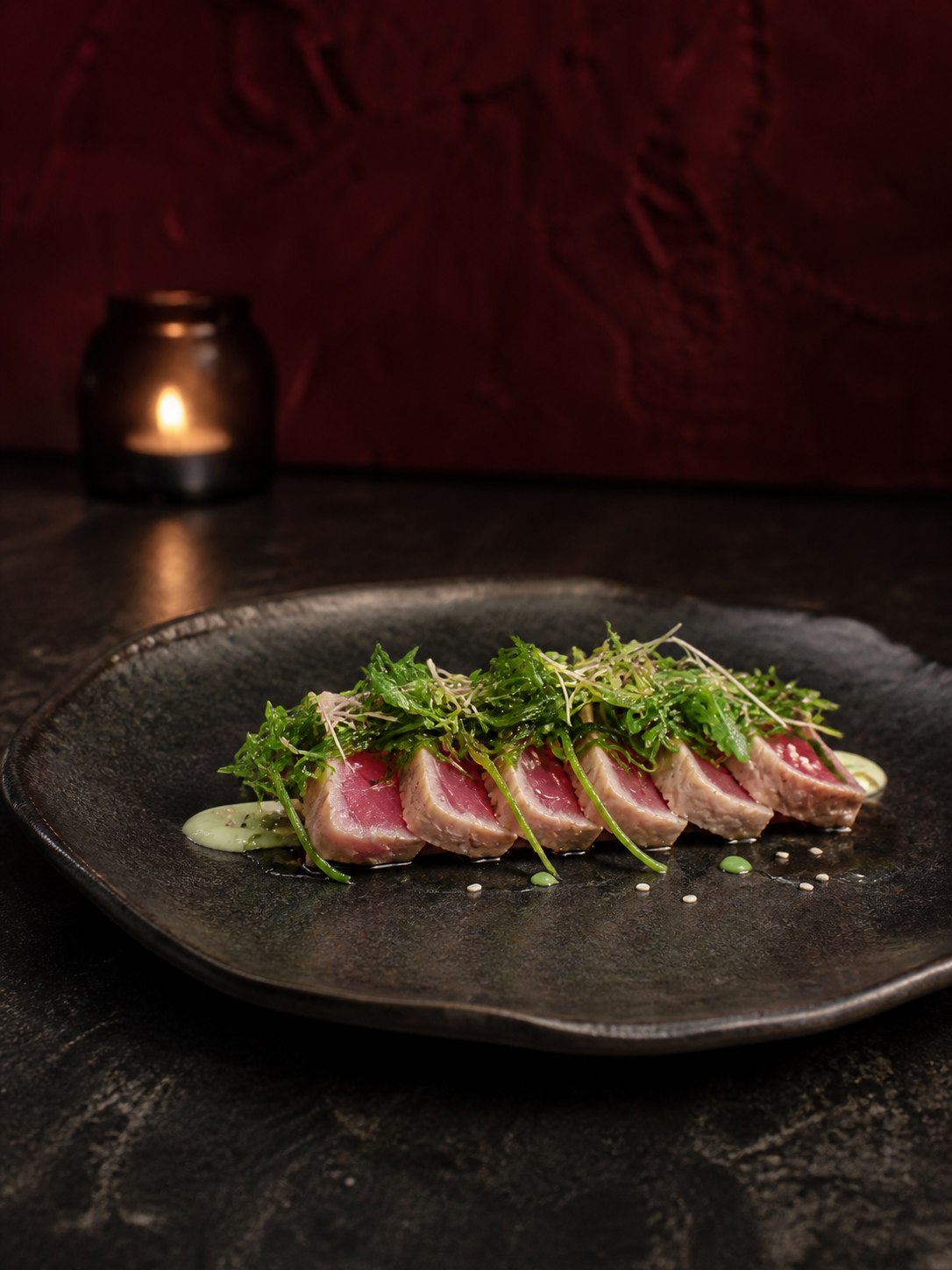 Seared tuna winter course against a burgundy backdrop